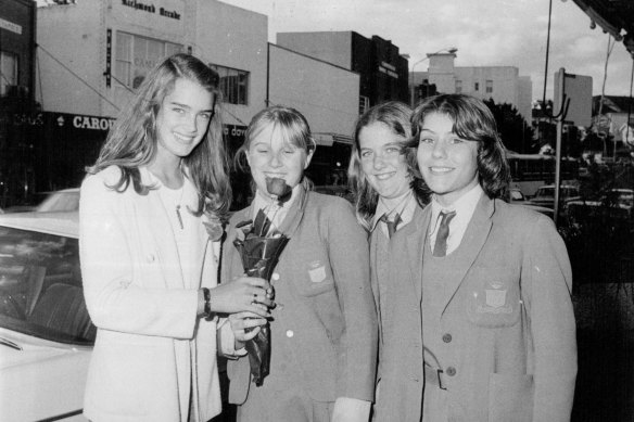Local schoolgirls present actress Brooke Shields with a rose at Rose Bay, August 10, 1979.