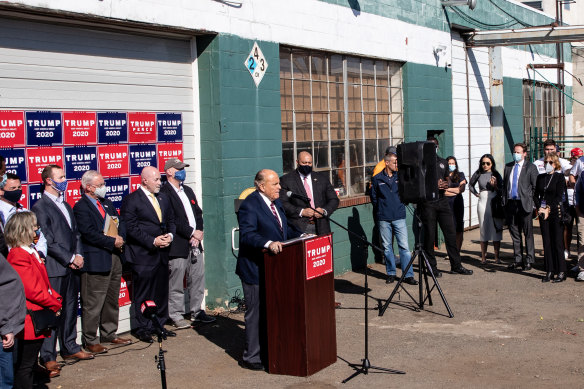 Rudy Giuliani, an attorney for the President, speaks to the media at a press conference held in the car park of a landscaping company in Philadelphia, Pennsylvania.