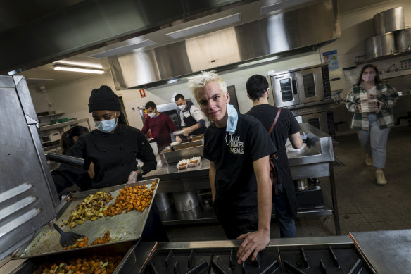 Alex Dekker and other volunteers prepare meals in the large council catering kitchen his burgeoning organisation has had to rent to cater for demand.