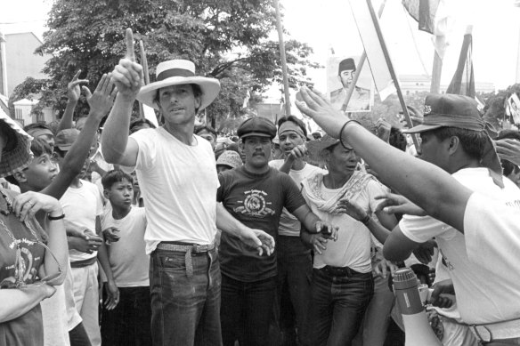 Director Peter Weir gives a lead to hit extras during rehearsals for the spectacular demonstration scene.