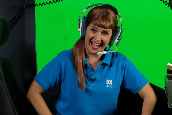 The perpetually cheerful Lois Price (Emily Taheny) reporting from the Mad As Helicopter.