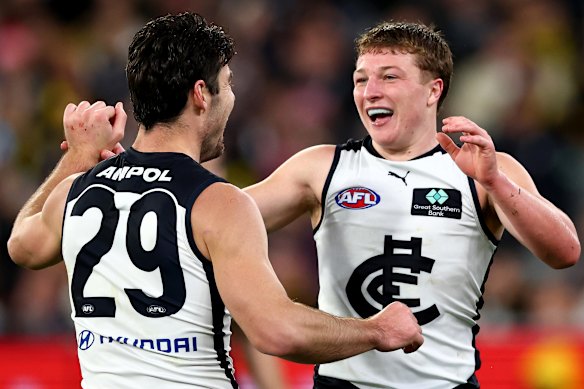 George Hewett is congratulated by Talor Byrne after kicking a goal.