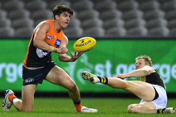 Giant Sam Taylor looks to handball.