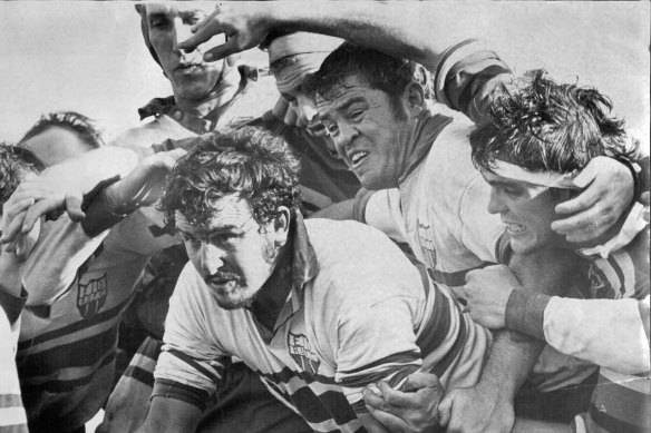 Barry "Tizza" Taylor, second from right, protects Ken Taylor (no relation) in a rugby union match in 1972. 