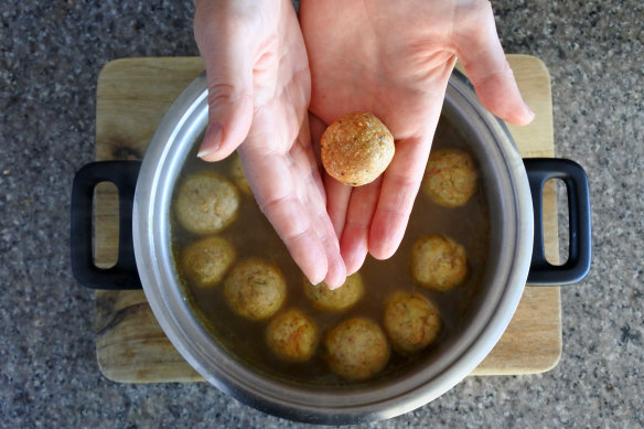 Preparing matzah balls and chicken soup, a Passover classic.