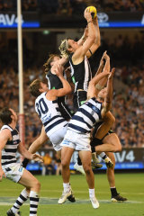 On the rise: Darcy Moore flies high for the Pies against Geelong in round one.
