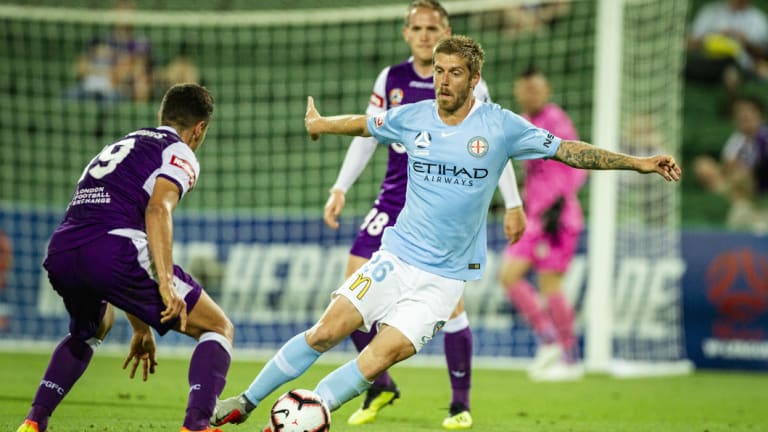 Full stretch: City's Luke Brattan swerves to avoid Perth's Christopher Ikonomidis