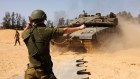 A soldier directs Israeli tanks near a border crossing to the southern Gaza strip, Israel, on Sunday, May 5, 2024. A Hamas delegation has reportedly arrived in Cairo for new talks aimed at reaching a cease-fire in Gaza, where the war between the Iran-backed militant group and Israel is nearing the seven-month mark.