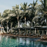 The swimming pool is shaded by palm trees – a true oasis in the middle of the outback.