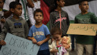 People hold banners reading “Let Gaza Live” and “Forgive Gaza”. 