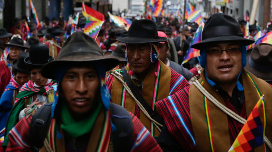 Supporters of ousted president Evo Morales take to the streets wearing traditional ponchos and waving Wiphala flags, a symbol used by the area's indigenous peoples.
