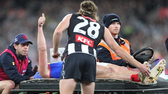 Collingwood defender Nathan Murphy consoles Angus Brayshaw as he leaves the ground after being concussed in the qualifying final. Both players are now retired due to medical advice following a series of concussions