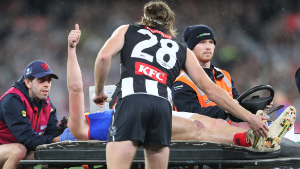 Collingwood defender Nathan Murphy consoles Angus Brayshaw as he leaves the ground after being concussed in the qualifying final. Both players are now retired due to medical advice following a series of concussions