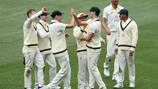 Pat Cummins of Australia is congratulated by teammates after taking a catch to dismiss Kagiso Rabada of South Africa during day four of the second Test.