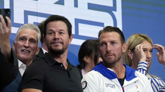Mark Wahlberg with F45 CEO and co-founder Adam Gilchrist at the 2021 NYSE float with Greg Norman in the background.