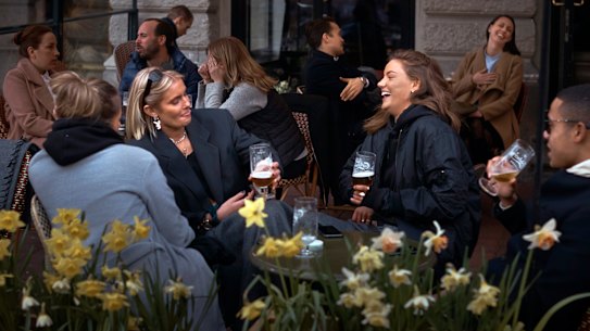 People chat and drink in Stockholm, which has not experienced the same lockdowns imposed on other European cities.