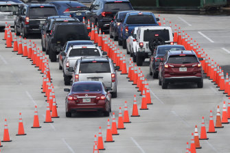 Lines of cars wait to be checked in at a COVID-19 testing site outside Hard Rock Stadium in Miami Gardens, Florida. 