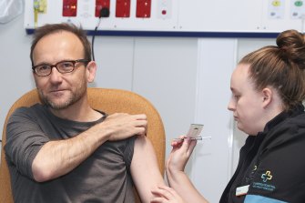 Greens leader Adam Bandt receives a vaccination from registered nurse Felicity Manson at the COVID-19 surge centre in Canberra on Tuesday.