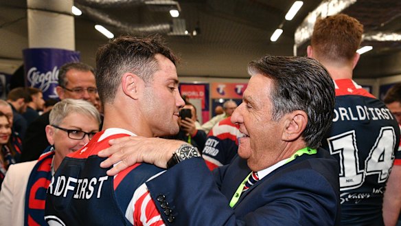 Roosters chairman Nick Politis, pictured with Cooper Cronk, has steered his club into the black.