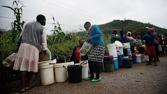 People queue for fresh water in Chimanimani, Zimbabwe on Saturday after Cyclone Idai caused floods that swept through Mozambique, Zimbabwe and Malawi.