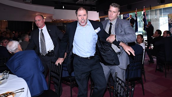 A protester (centre) is removed from the Valley Chamber of Commerce.