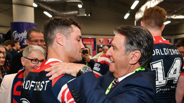 Roosters chairman Nick Politis, pictured with Cooper Cronk, has steered his club into the black.