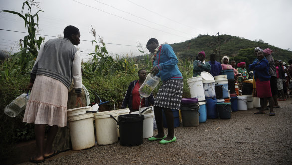 People queue for fresh water in Chimanimani, Zimbabwe on Saturday after Cyclone Idai caused floods that swept through Mozambique, Zimbabwe and Malawi.