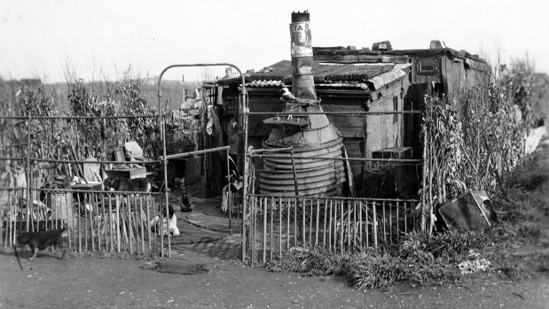 One of the tin shanties built on the Dudley Flats, the waste-grounds in West Melbourne, where many of the city's homeless lived. Everything used in the building has been salvaged from the rubbish tip.
