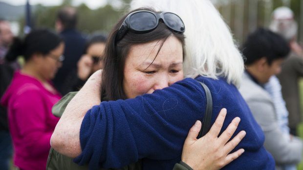 Jangchu Wangchuk is hugged by a supporter at the rally outside Parliament House on Friday.