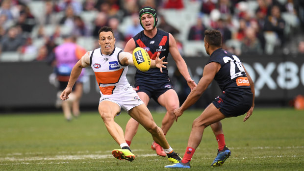 Up for grabs: Dylan Shiel attempts to take possession under pressure from Angus Brayshaw and Jay Kennedy-Harris.