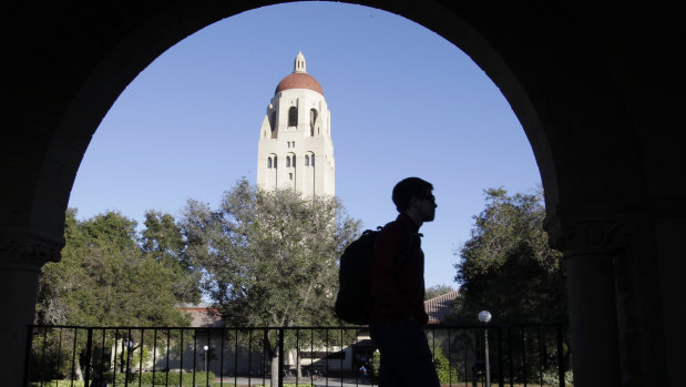 A student walks in front of Hoover Tower on the Stanford University campus in Palo Alto, California.