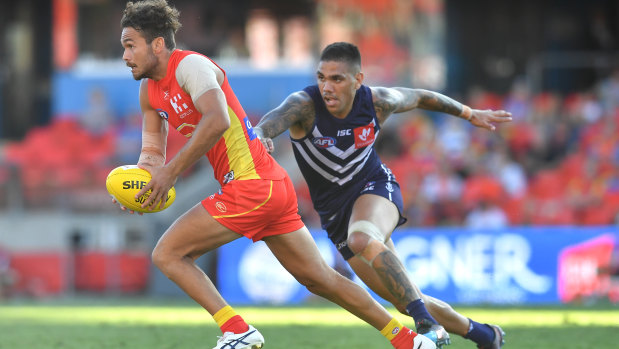 Walters puts the pressure on Gold Coast's Jarrod Harbrow to try retain the ball inside Fremantle's forward half last week.
