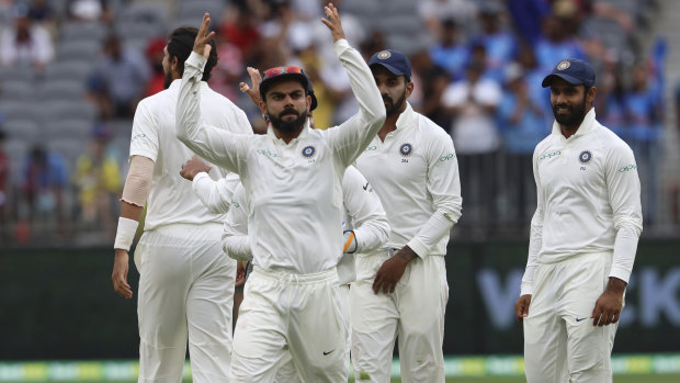 Revved up: Captain Virat Kohli exhorts the crowd to cheer after India claimed the wicket of Australia's Peter Handscomb on day three of the second Test in Perth.