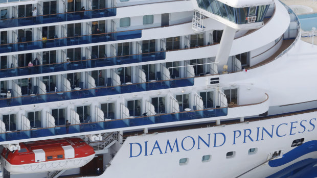 Some passengers are seen on the Diamond Princess as the cruise ship is anchored at Yokohama Port to replenish  supplies.