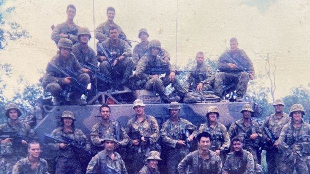 Dave Jensen during his army days, seated third from left on top of the armoured personnel carrier. 