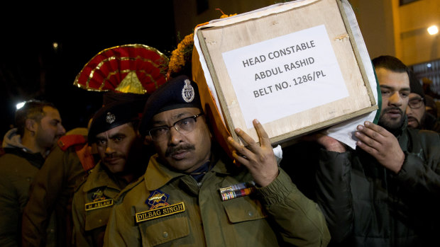Indian police officers carry the coffin of their colleague during a wreath-laying ceremony in Srinagar, Indian controlled Kashmir, on Monday.