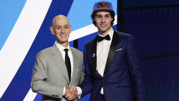 Josh Giddey on stage with NBA commissioner Adam Silver after hearing his name read out for the sixth overall pick in the 2021 draft.