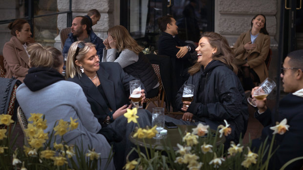 People chat and drink in Stockholm, which has not experienced the same lockdowns imposed on other European cities.