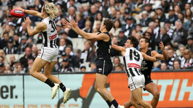 Line up: Darcy Moore of the Magpies, Charlie Curnow of the Blues, Levi Greenwood of the Magpies and Jack Silvagni of the Blues contest the ball at the MCG.