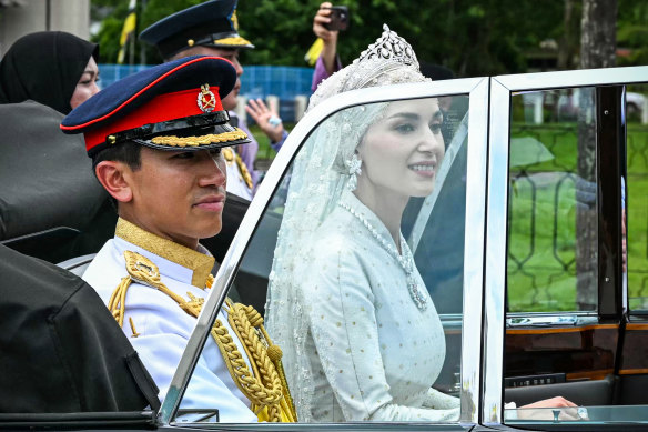 Prince Abdul Mateen and Yang Mulia Anisha Rosnah are seen in their car during their wedding procession.