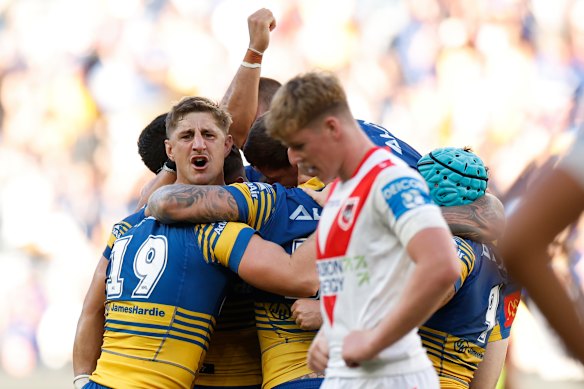 Parra players swamp Zac Lomax after his game-breaking field goal.