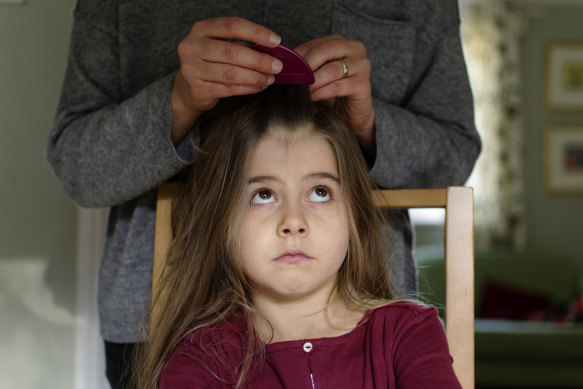 In the moment: Removing nits with a fine-tooth comb is a job that can’t be rushed.