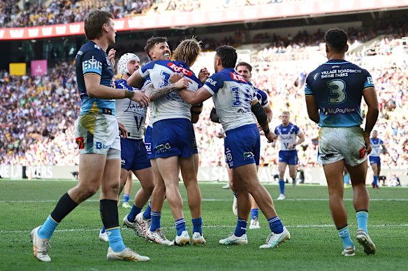 Jacob Preston celebrates with teammates after scoring for the Bulldogs.