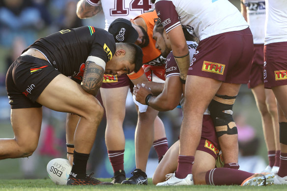 Sea Eagles forward Martin Taupau is attended to by a trainer on Saturday.