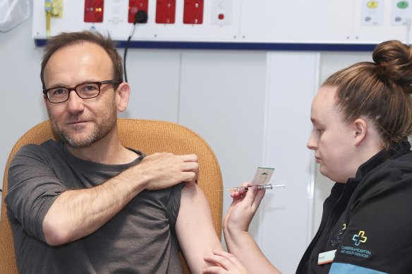 Greens leader Adam Bandt receives a COVID-19 vaccination from registered nurse Felicity Manson at the COVID-19 surge centre in Canberra on Tuesday.