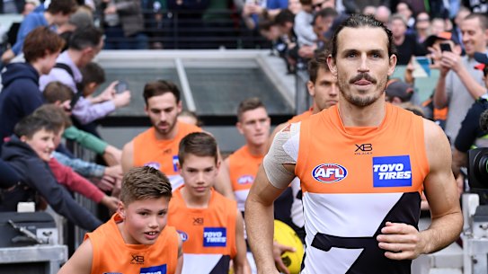 Phil Davis leads GWS onto the MCG.