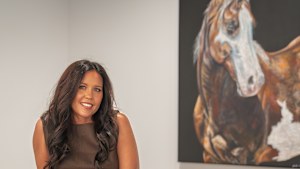 Horse breeder and equine artist Nicole Slater with works from her new HOTA exhibition, Rose Gold.