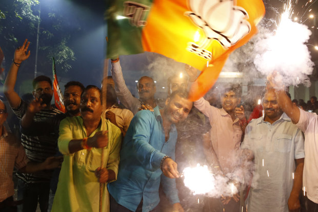 Supporters of India's ruling Bharatiya Janata Party in Lucknow celebrate the revoking of Kashmir's special status.