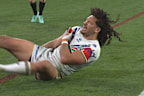 Dallin Watene-Zelezniak reaches for his shoulder after scoring a try for the Warriors.