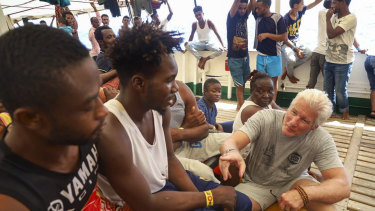 Actor Richard Gere, right, talks with migrants aboard the Open Arms Spanish humanitarian boat last week.